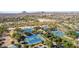 Aerial view of community tennis courts and surrounding neighborhood, landscaped with mature trees at 6656 W Springfield Way, Florence, AZ 85132