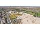 Scenic aerial view of community baseball fields and green spaces surrounded by mountain views at 6656 W Springfield Way, Florence, AZ 85132