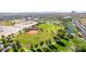 Scenic aerial view of baseball field surrounded by green spaces and lush mature trees at 6656 W Springfield Way, Florence, AZ 85132