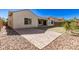 Spacious backyard featuring a brick patio, green lawn, and desert landscaping at 6656 W Springfield Way, Florence, AZ 85132