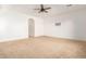 Spacious room featuring neutral carpeting, a ceiling fan and a tv mount at 6656 W Springfield Way, Florence, AZ 85132