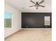 Bedroom features neutral carpet, a statement wall, a ceiling fan and bright windows at 6656 W Springfield Way, Florence, AZ 85132