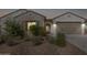 Charming single-story home featuring a two-car garage, desert landscaping, and a cozy entryway at 6656 W Springfield Way, Florence, AZ 85132