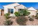 Charming single-story home featuring a well-maintained desert landscaped front yard and a neutral color scheme at 6656 W Springfield Way, Florence, AZ 85132