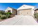 Well-manicured single-story house with a spacious driveway leading to a two-car garage in a desirable community at 6656 W Springfield Way, Florence, AZ 85132