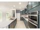 Bright kitchen features gray cabinets, stainless steel appliances, a large island with white counters and a walk-in pantry at 6656 W Springfield Way, Florence, AZ 85132