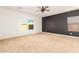 Spacious main bedroom features a ceiling fan, two windows, a statement wall and neutral carpeting at 6656 W Springfield Way, Florence, AZ 85132