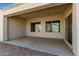 Covered patio with brick flooring and view to landscaped backyard at 6656 W Springfield Way, Florence, AZ 85132