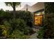 Lush backyard garden with plants and flowers, offering a view of the home's cozy bedroom through the window at 6711 E Camelback Rd # 81, Scottsdale, AZ 85251