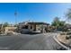 Welcoming entrance to the community with desert landscaping, stylish architecture, and a secure gate at 6711 E Camelback Rd # 81, Scottsdale, AZ 85251