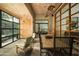 Bright dining area boasts wooden accents, modern lighting, and views of the exterior and bedroom through large windows at 6711 E Camelback Rd # 81, Scottsdale, AZ 85251