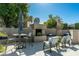 Inviting outdoor fireplace with comfortable seating, perfect for enjoying evenings outside at 6711 E Camelback Rd # 81, Scottsdale, AZ 85251