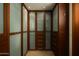 Custom walk-in closet features beautiful wood cabinetry, frosted glass panels and functional drawer space at 6711 E Camelback Rd # 81, Scottsdale, AZ 85251