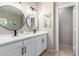 Well-lit bathroom featuring dual sinks, modern fixtures, and a neutral color scheme at 6745 N 93Rd Ave # 1166, Glendale, AZ 85305