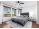 Bright bedroom featuring a ceiling fan, multiple windows, and a patterned grey bedspread at 6745 N 93Rd Ave # 1166, Glendale, AZ 85305