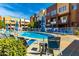 A view of the community pool with lounge chairs and umbrellas, ideal for relaxation at 6745 N 93Rd Ave # 1166, Glendale, AZ 85305