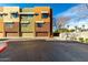 View of the building's exterior featuring colorful facades, garage doors and a clear blue sky at 6745 N 93Rd Ave # 1166, Glendale, AZ 85305