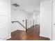 Bright hallway with dark wood floors, leading to the upper levels of the home at 6745 N 93Rd Ave # 1166, Glendale, AZ 85305