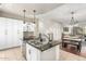 Open-concept kitchen featuring an island with seating and stylish pendant lighting at 6745 N 93Rd Ave # 1166, Glendale, AZ 85305