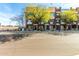 A street view of a modern brownstone featuring landscaped sidewalks and vibrant greenery at 6745 N 93Rd Ave # 1166, Glendale, AZ 85305