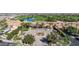 Aerial view of a clubhouse featuring a courtyard, fountain, and manicured greenery, set against a golf course backdrop at 678 E Cobble Stone Dr, Queen Creek, AZ 85140