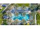 Aerial shot of a sparkling pool lined with chairs and umbrellas, nestled among lush palm trees at 678 E Cobble Stone Dr, Queen Creek, AZ 85140