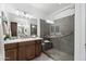 Beautiful bathroom with a tiled shower, glass door, and a double sink vanity at 678 E Cobble Stone Dr, Queen Creek, AZ 85140