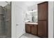 Bathroom featuring a tiled shower, wood vanity, and ample storage at 678 E Cobble Stone Dr, Queen Creek, AZ 85140