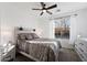 Bedroom with a ceiling fan, natural light, and stylish furnishings at 678 E Cobble Stone Dr, Queen Creek, AZ 85140