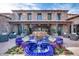 Stunning exterior of home featuring a blue tiled fountain, lush landscaping, and stone facade at 678 E Cobble Stone Dr, Queen Creek, AZ 85140