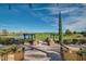 Scenic view of the golf course from an elevated outdoor patio with pergola and lush landscaping at 678 E Cobble Stone Dr, Queen Creek, AZ 85140