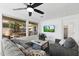 Cozy living room with large windows, a ceiling fan, and comfortable seating creating an inviting atmosphere at 678 E Cobble Stone Dr, Queen Creek, AZ 85140