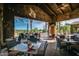 Covered outdoor dining area with comfortable seating and a view of the golf course at 678 E Cobble Stone Dr, Queen Creek, AZ 85140