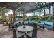 Outdoor dining area with tables and chairs near a sparkling pool, perfect for enjoying meals in a resort-style setting at 678 E Cobble Stone Dr, Queen Creek, AZ 85140