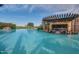 Luxurious pool featuring a swim-up bar and cascading waterfall, creating a resort-like experience at 678 E Cobble Stone Dr, Queen Creek, AZ 85140