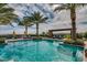 Serene pool with lounge chairs, umbrellas, and lush landscaping, providing a tranquil escape for residents at 678 E Cobble Stone Dr, Queen Creek, AZ 85140