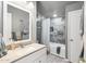 Well-lit bathroom with modern gray tile shower and new countertops at 690 S 92Nd Pl, Mesa, AZ 85208