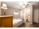 Comfortable bedroom with ceiling fan, adjacent half bathroom and wood-look flooring at 690 S 92Nd Pl, Mesa, AZ 85208