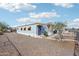 Charming mobile home with blue siding, surrounded by desert landscaping at 690 S 92Nd Pl, Mesa, AZ 85208