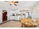 Open kitchen and dining area with white appliances, cabinetry, and a ceiling fan for comfortable living at 690 S 92Nd Pl, Mesa, AZ 85208