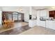 Bright kitchen with white cabinets, laminate countertops, and an adjacent dining area at 690 S 92Nd Pl, Mesa, AZ 85208