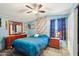 Serene main bedroom featuring blue walls, a ceiling fan, and ample closet space at 690 S 92Nd Pl, Mesa, AZ 85208