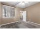 Carpeted bedroom with neutral colors, a ceiling fan, and window views at 7009 E Acoma Dr # 1046, Scottsdale, AZ 85254