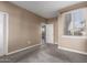 Carpeted bedroom with neutral colors, a window with blinds, and door to hallway at 7009 E Acoma Dr # 1046, Scottsdale, AZ 85254