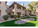 Building exterior showcasing balconies, private patios, desert rock landscaping, and well-maintained grounds at 7009 E Acoma Dr # 1046, Scottsdale, AZ 85254