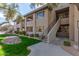 View of building #13 featuring exterior stairs, patios, and desert rock landscaping at 7009 E Acoma Dr # 1046, Scottsdale, AZ 85254