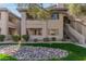 Exterior view of the condo building featuring balconies, patios, and desert landscaping at 7009 E Acoma Dr # 1046, Scottsdale, AZ 85254