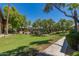 Serene common area featuring lush green grass, mature shade trees, and manicured landscaping at 7009 E Acoma Dr # 1046, Scottsdale, AZ 85254