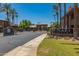 View of the community entrance and sign for The Plaza Residences with mature palm trees and lush landscaping at 7009 E Acoma Dr # 1046, Scottsdale, AZ 85254