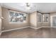 Bright living room with laminate flooring, a ceiling fan, and large windows at 7009 E Acoma Dr # 1046, Scottsdale, AZ 85254